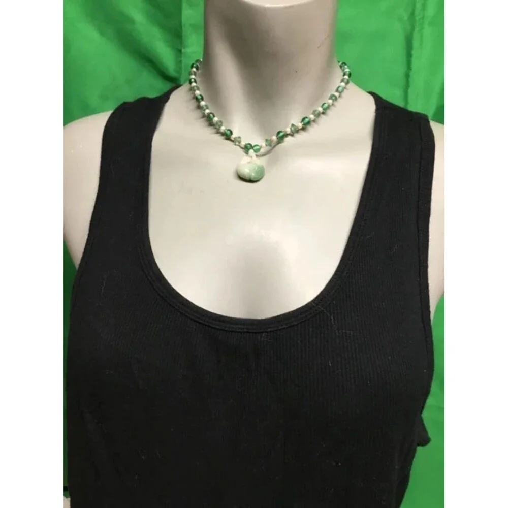 Jade and beads necklace, amazing artistry into that pendant,   Look Closer.